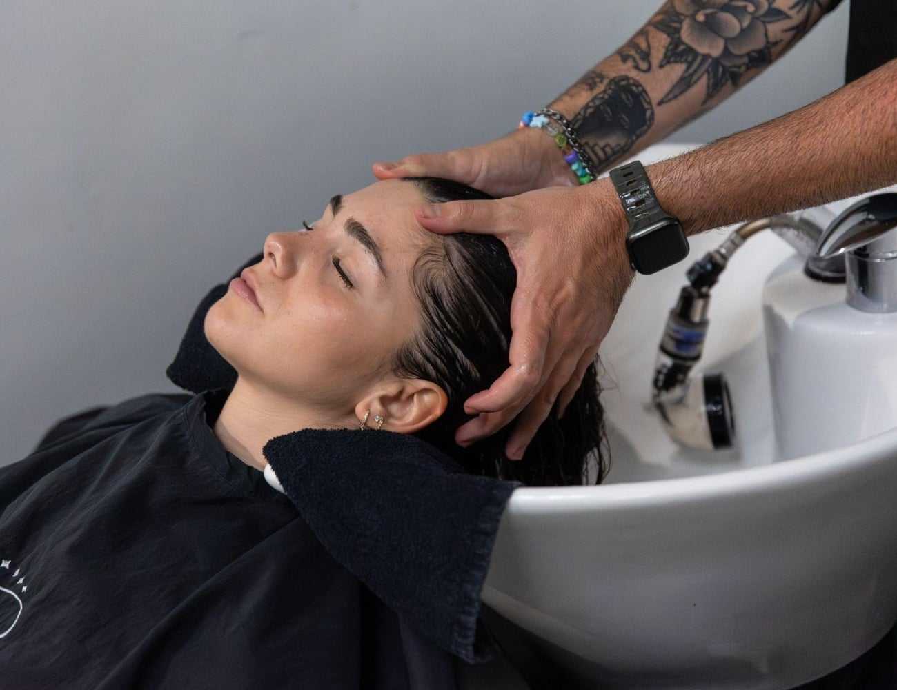 Person getting a relaxing hair wash at a salon.